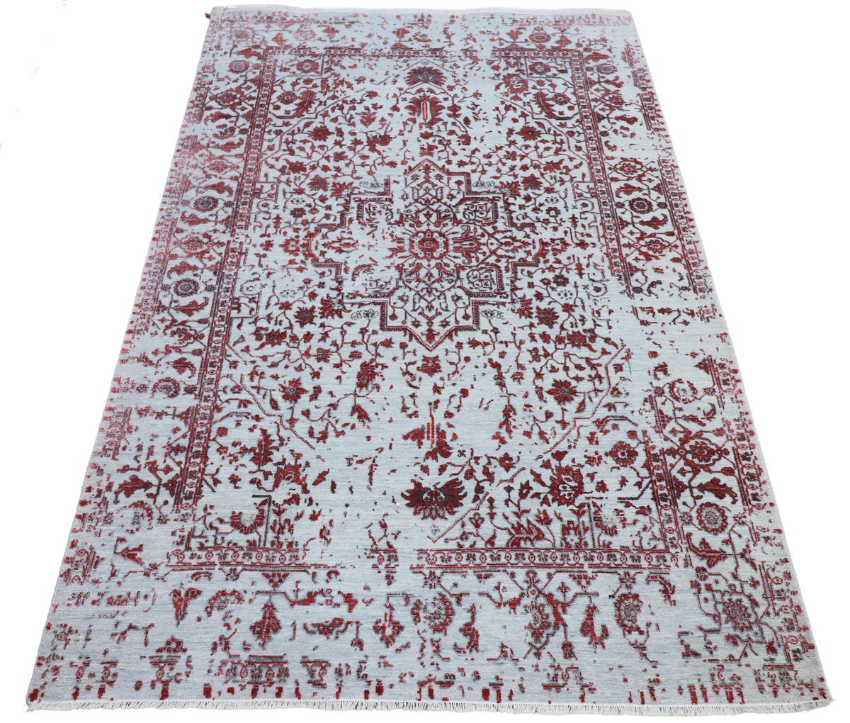 Light gray rectangular area rug with red central medallion and ornate patterned border