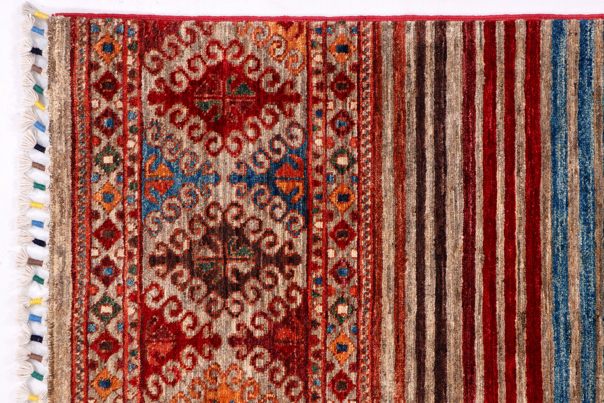 Red rug border with cream tassel fringe and striped trim