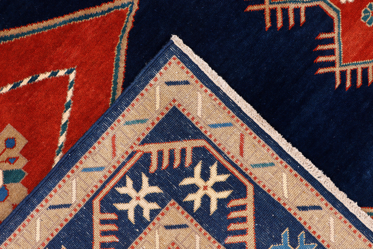 Rug corner detail with navy, red, and cream triangles and star ornaments.