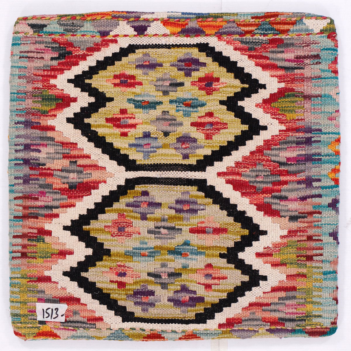 Kilim pillow cover close-up with red, black, and gold double medallion pattern