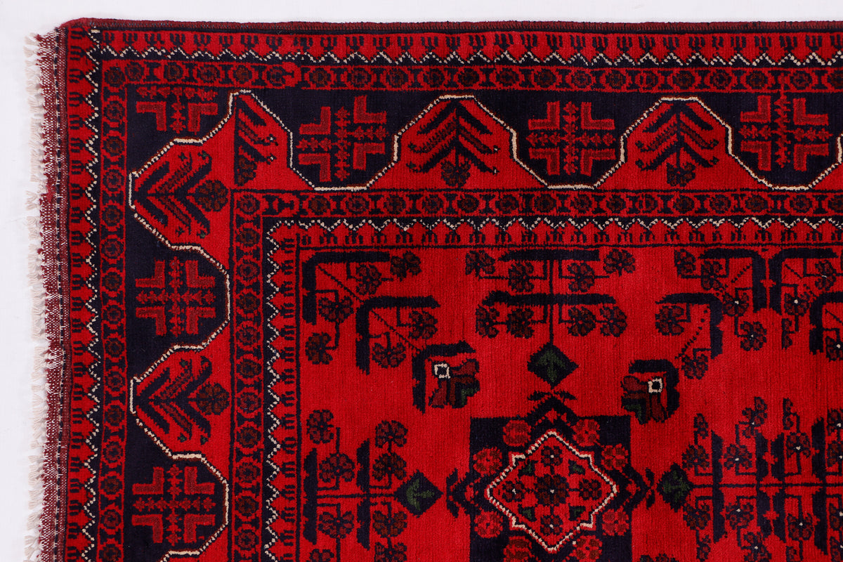 Khal Mohammadi red rug close-up with geometric motifs and patterned border