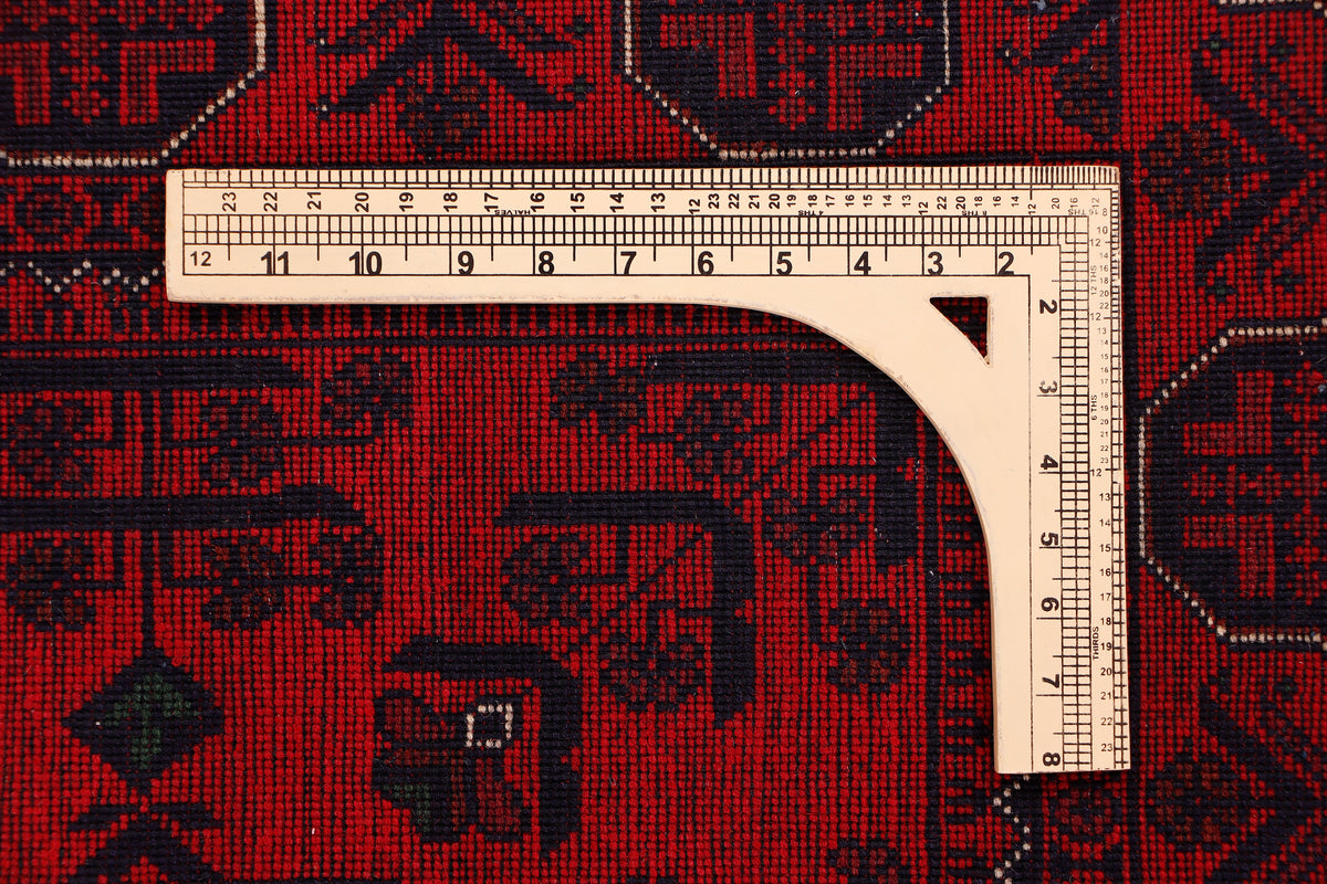 Khal Mohammadi red rug corner with geometric pattern and border, measuring ruler
