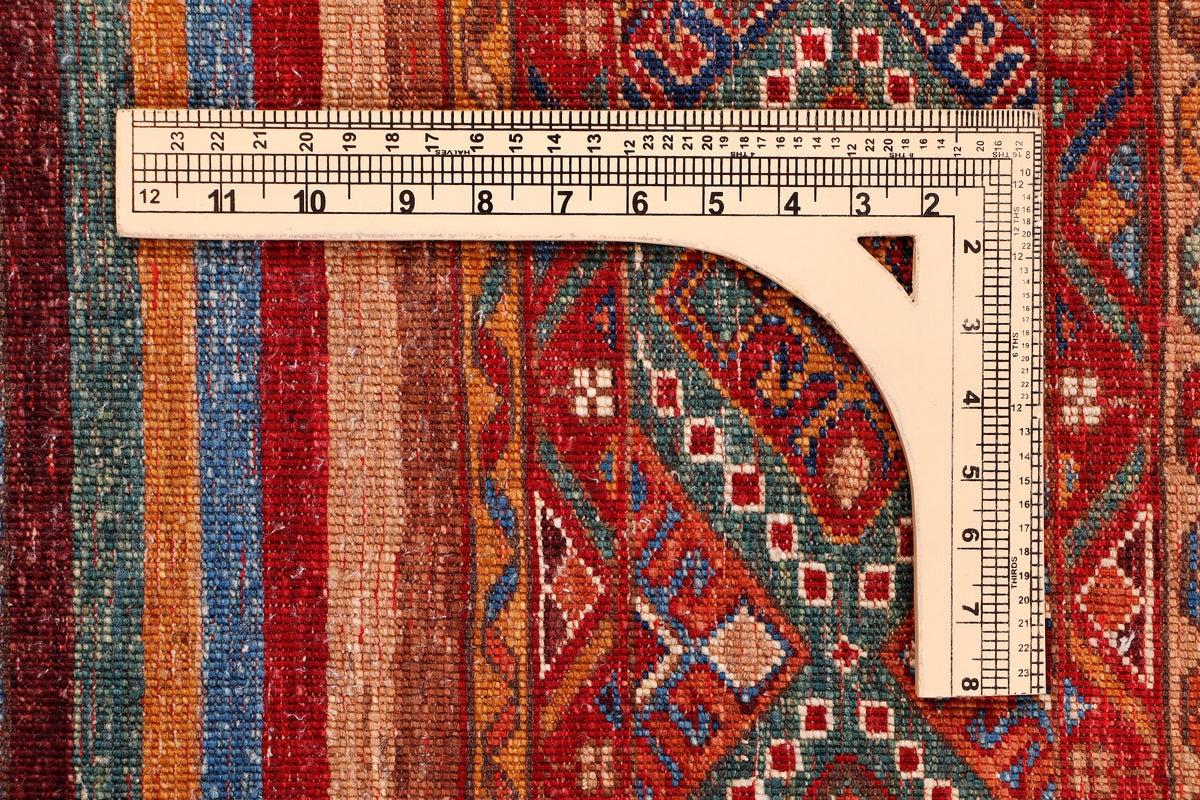 Wool rug with geometric pattern and measuring tape along curved edge