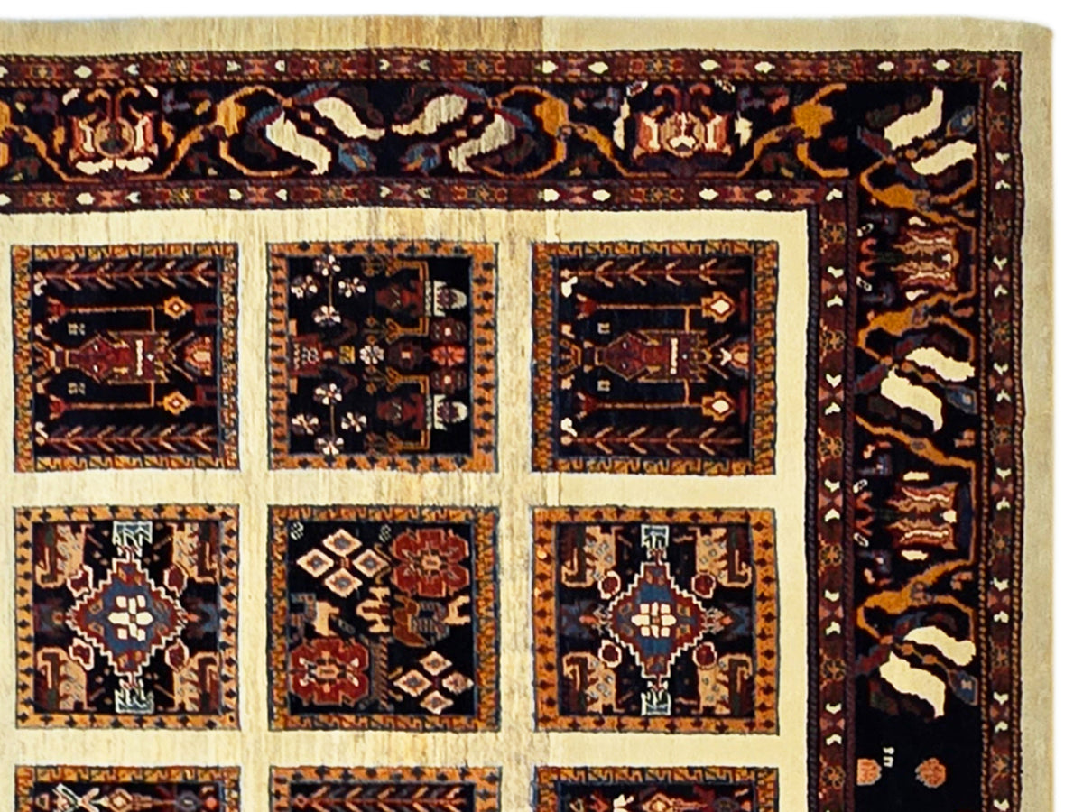 Loribaft rug close-up of tiled medallions in navy, rust, and cream border