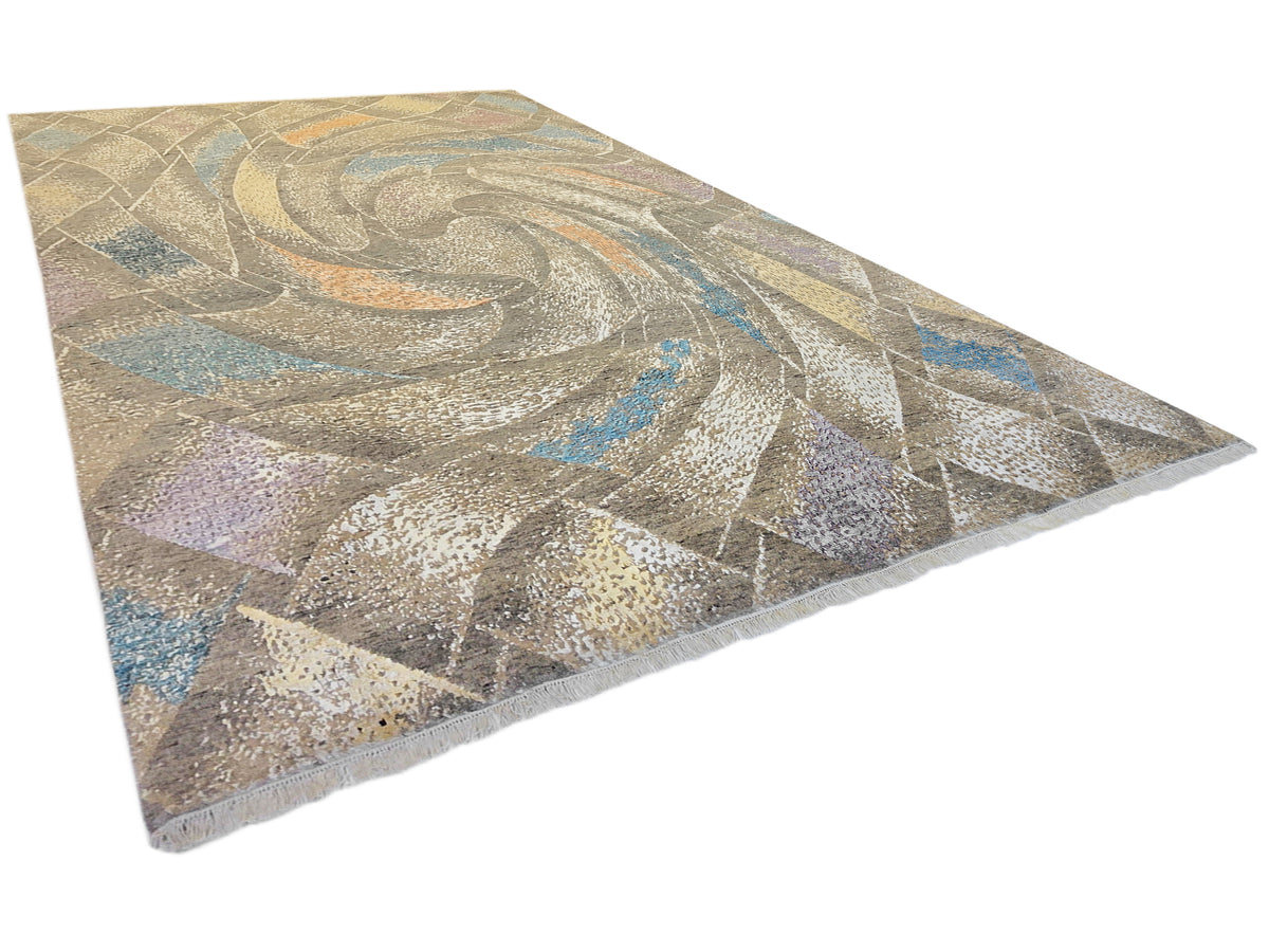Modern abstract area rug with speckled beige and gray tones and blue, purple, and orange accents
