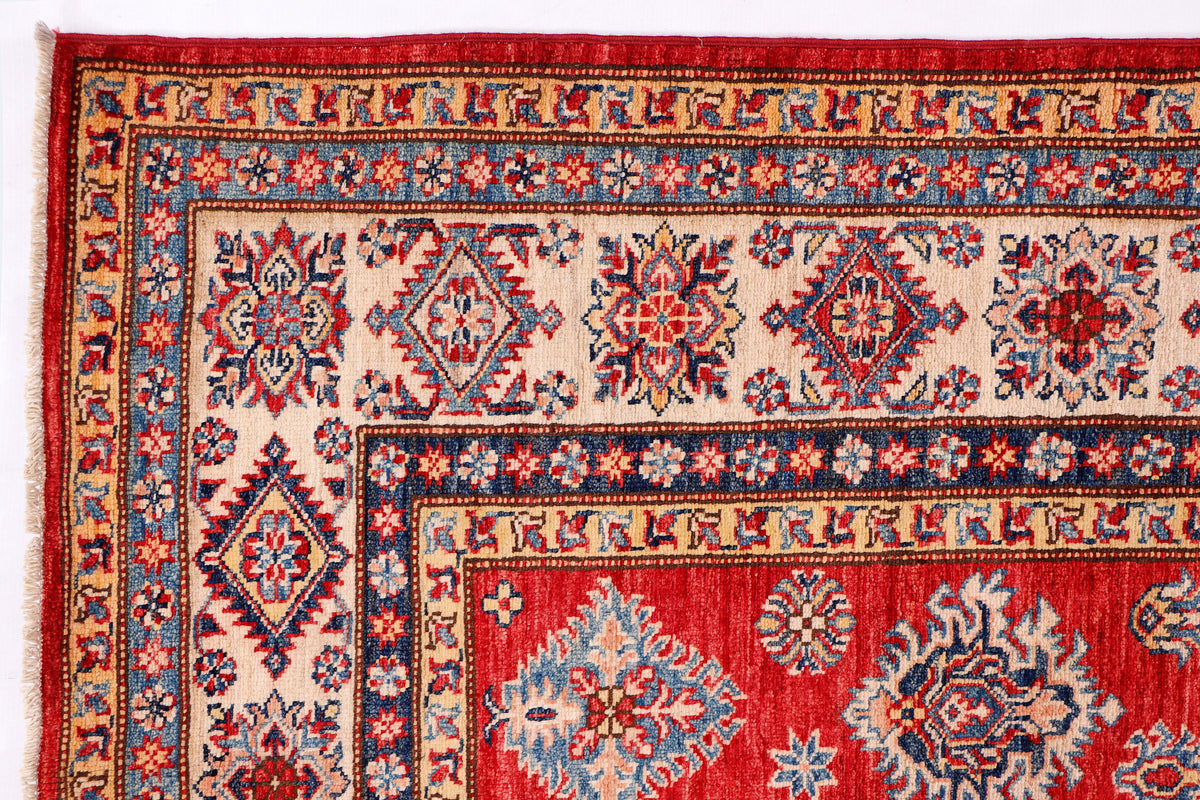 Red, blue, and ivory Kazak rug with ornate geometric medallions and border