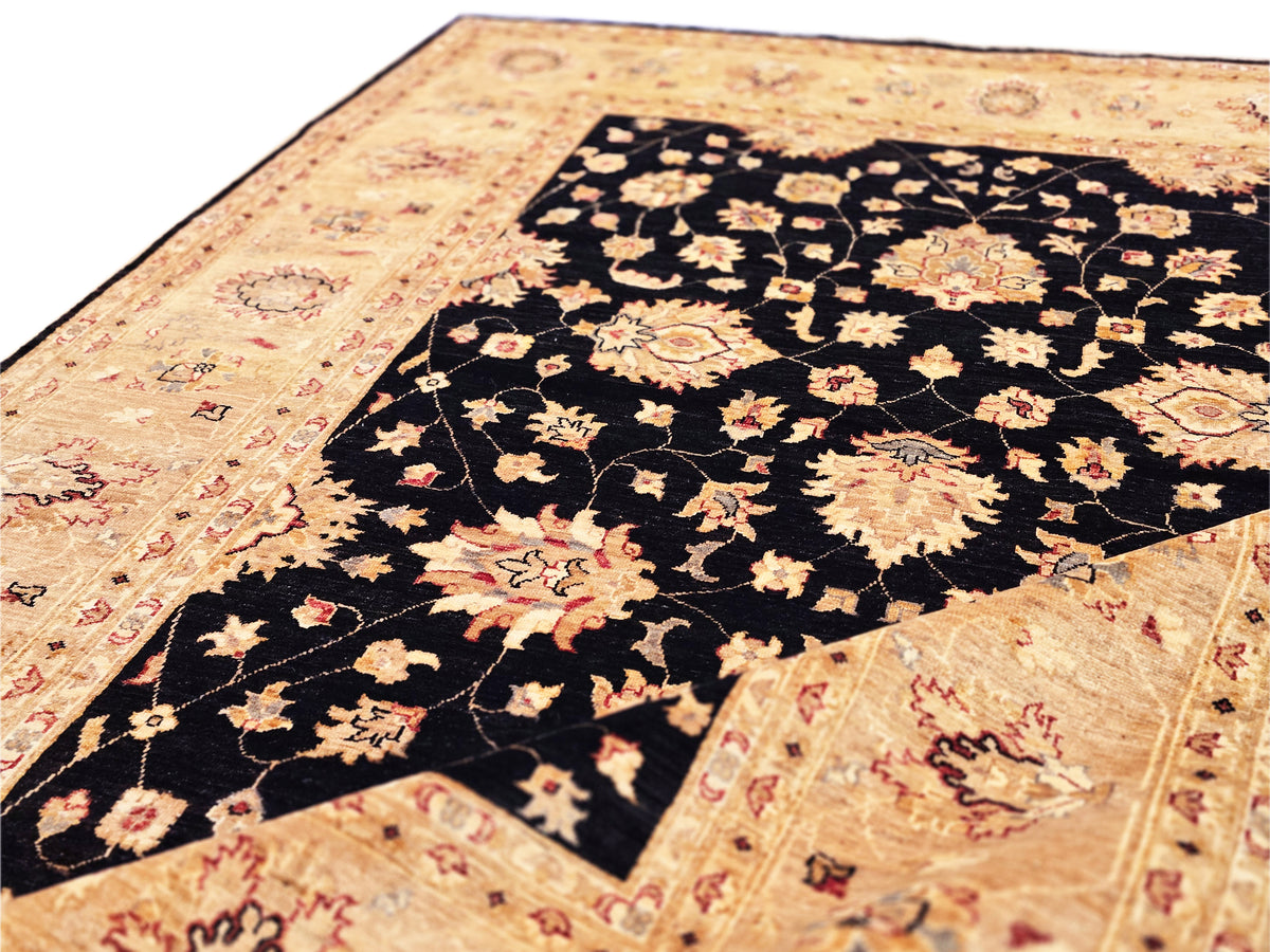 Afghan rug laid out flat: black center panel with floral motifs on beige border.