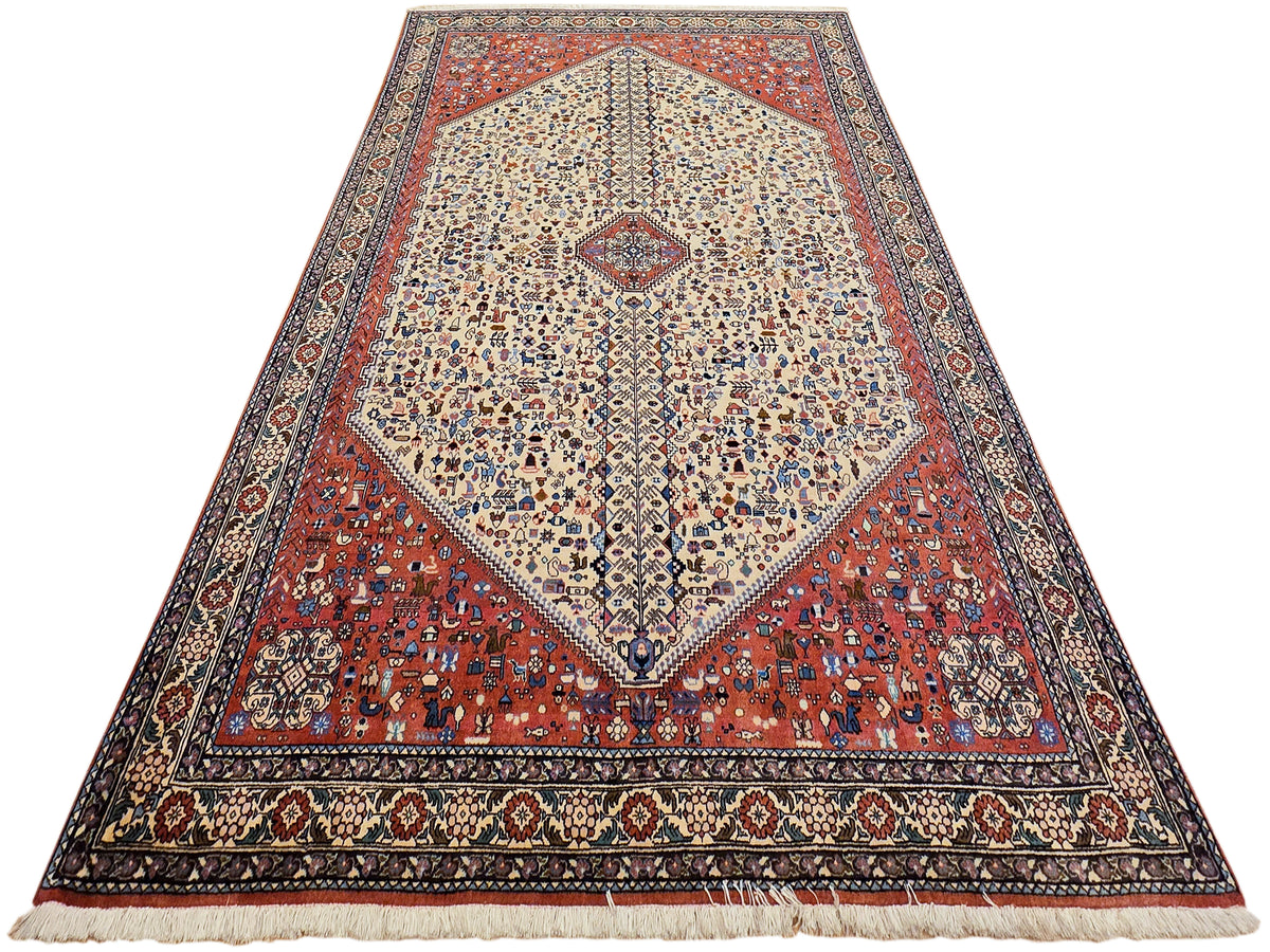 Rectangular rug with cream medallion, red geometric field, dark border and fringe edges