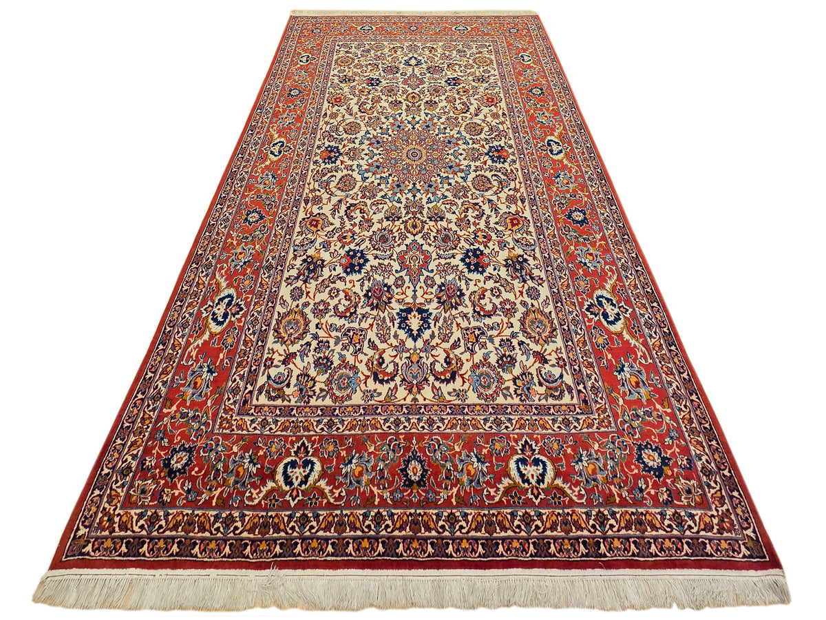Red and cream floral area rug with detailed border and light fringed ends