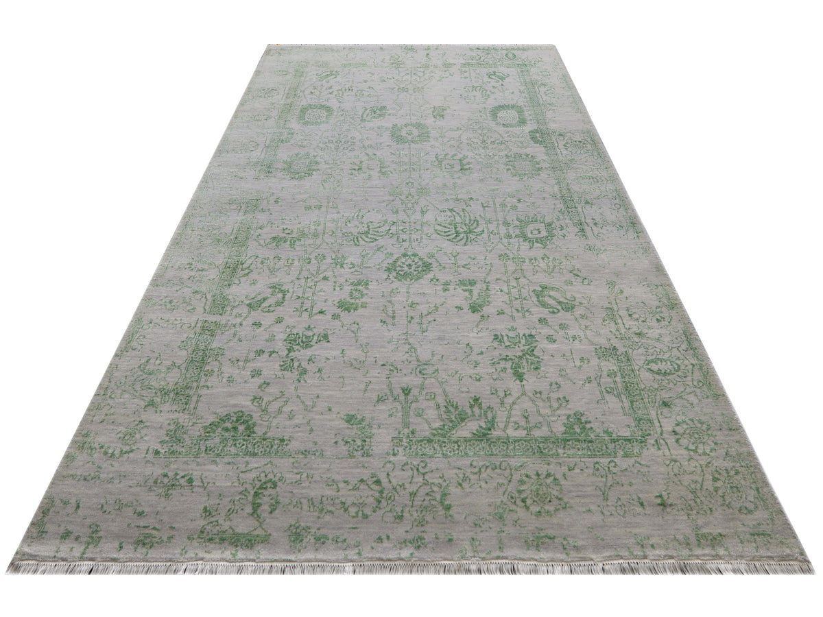 Light gray rectangular rug with green ornamental border and short fringe edge