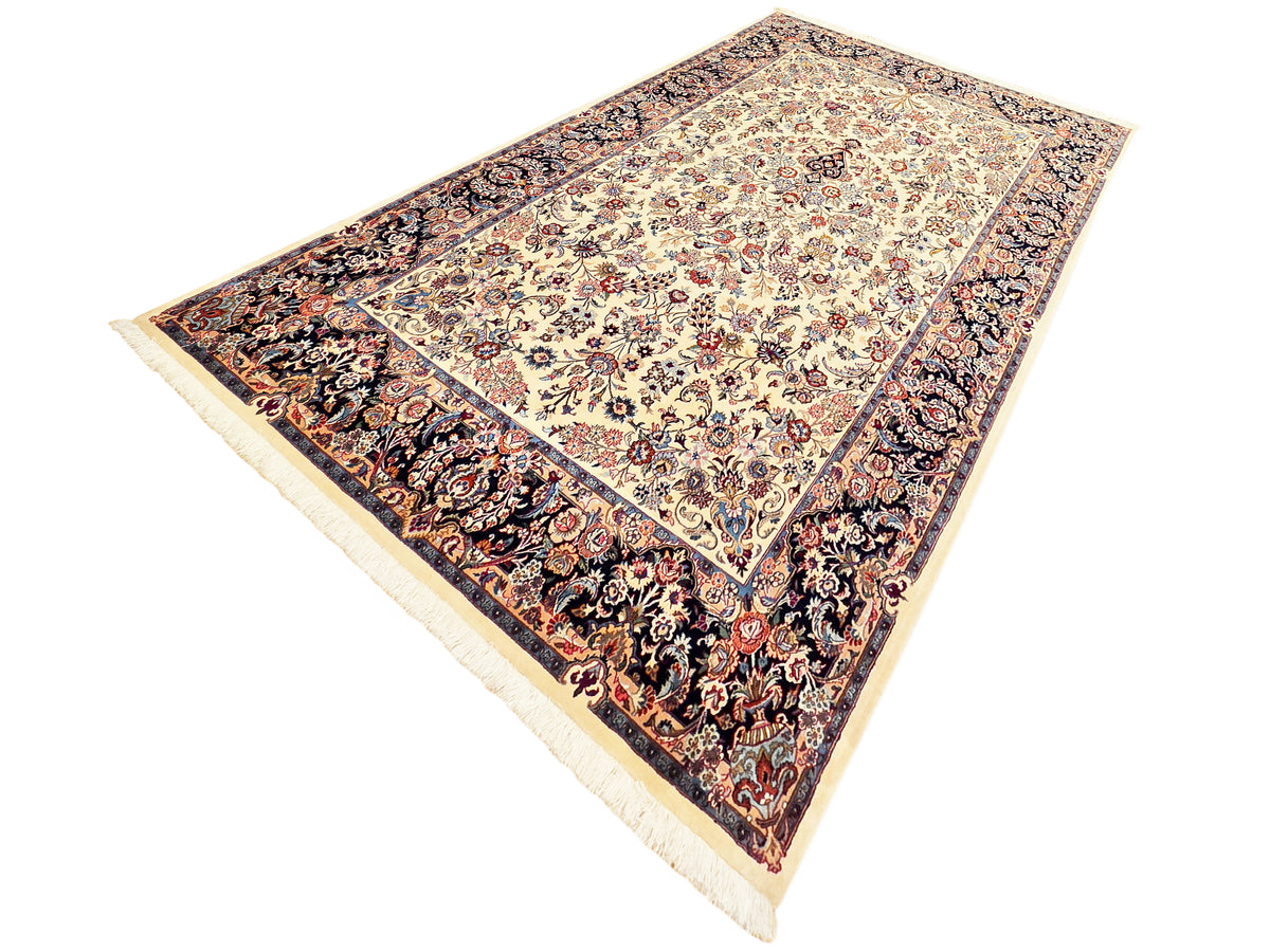 Rectangular rug laid diagonally, cream floral center, dark ornate border, cream fringes