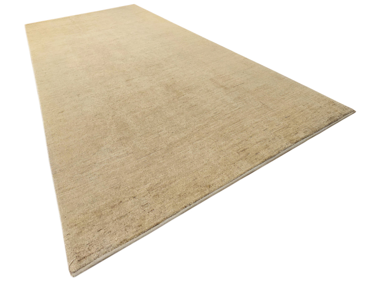 Light beige area rug with smooth flat weave and visible edge stitching