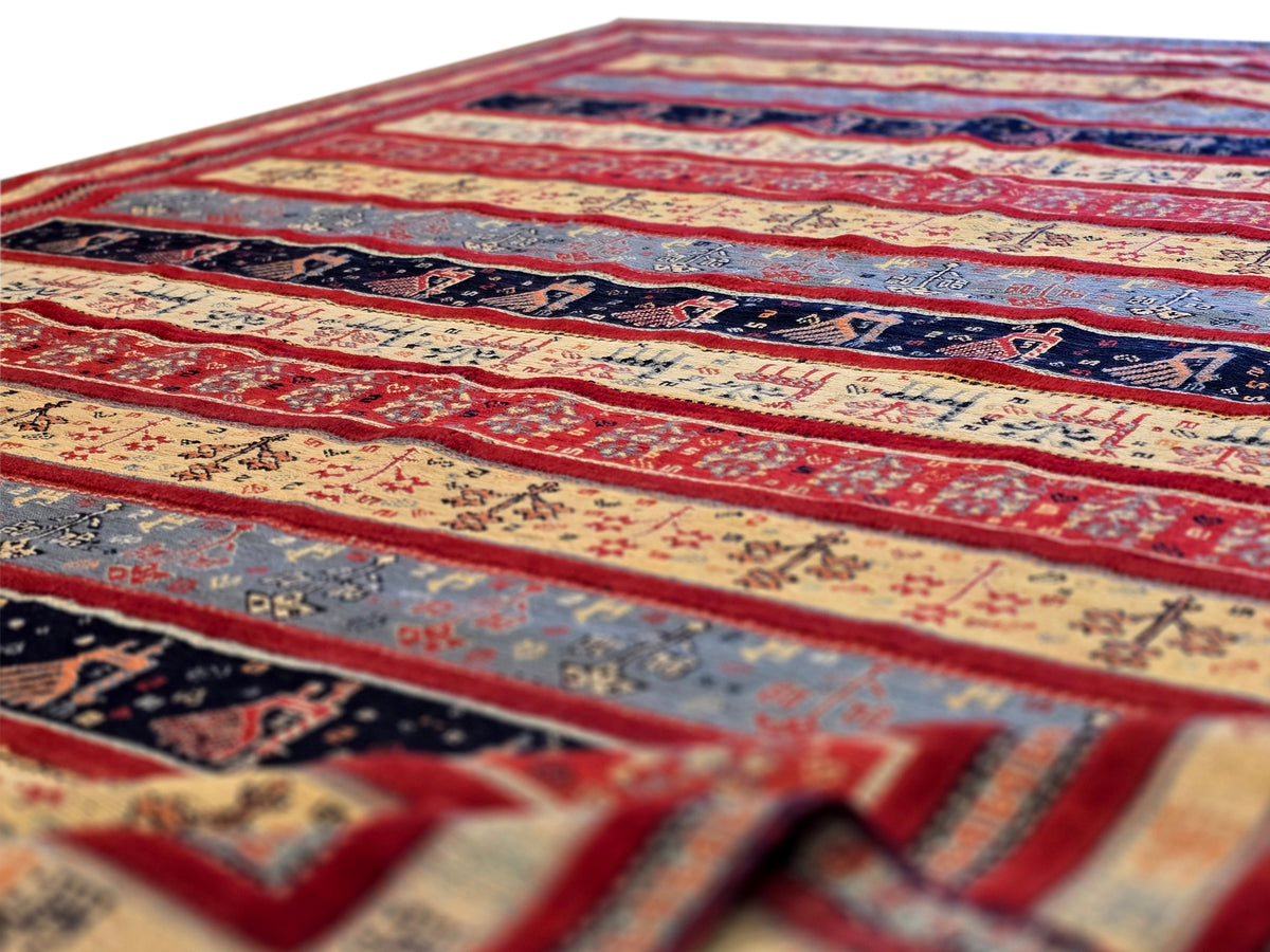 Rug surface with red, navy and cream stripes, small motifs, and short fringe edge