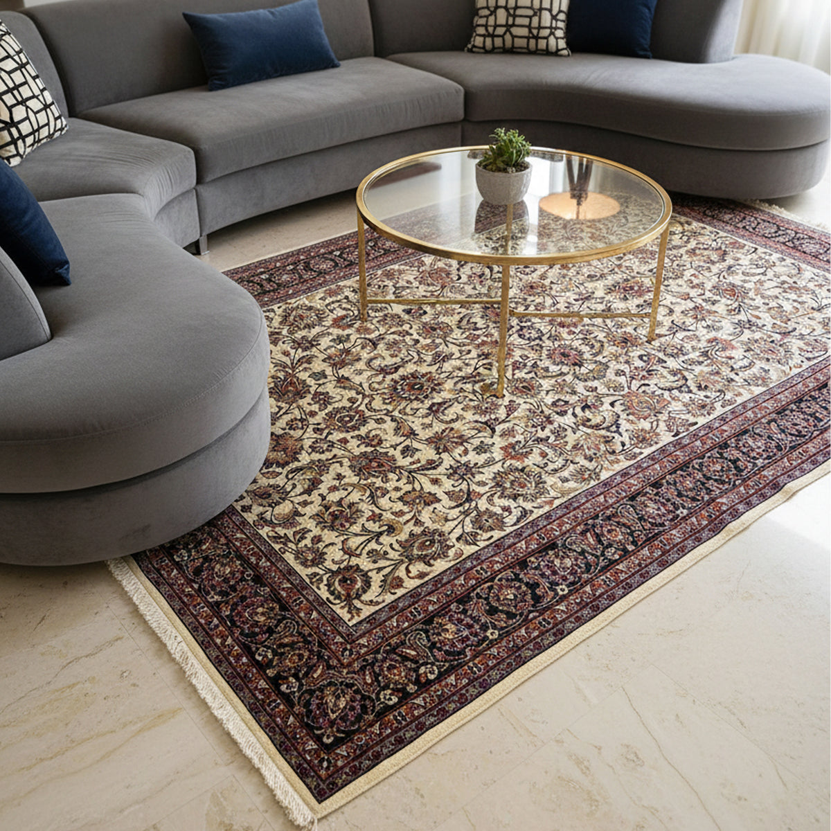 Cream floral rug with dark navy border laid on floor, fringed edge