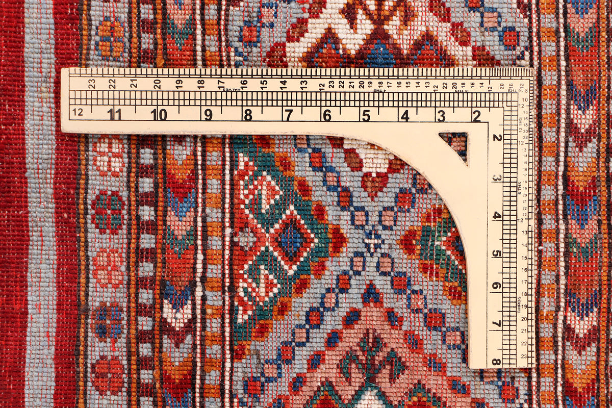 Geometric woven rug pattern with measuring ruler along the curved edge