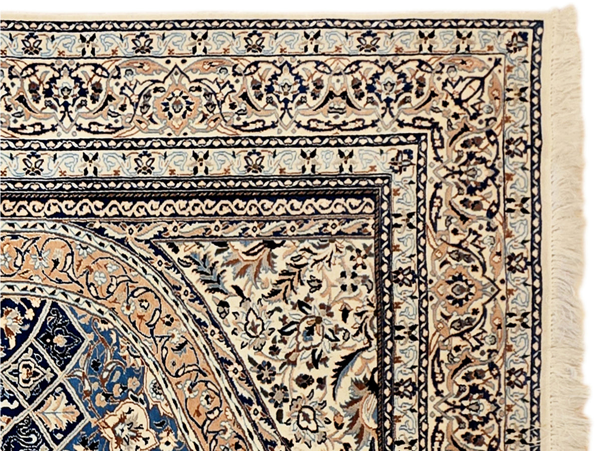 Blue, cream and tan patterned area rug with ornate border