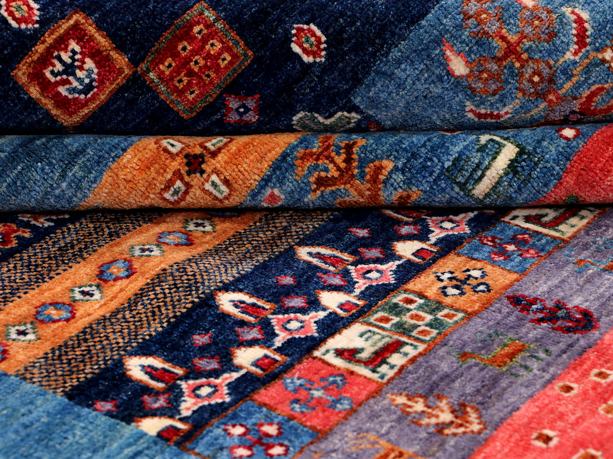 Gabbeh Afghan rug close-up with blue, orange, and red geometric patterns