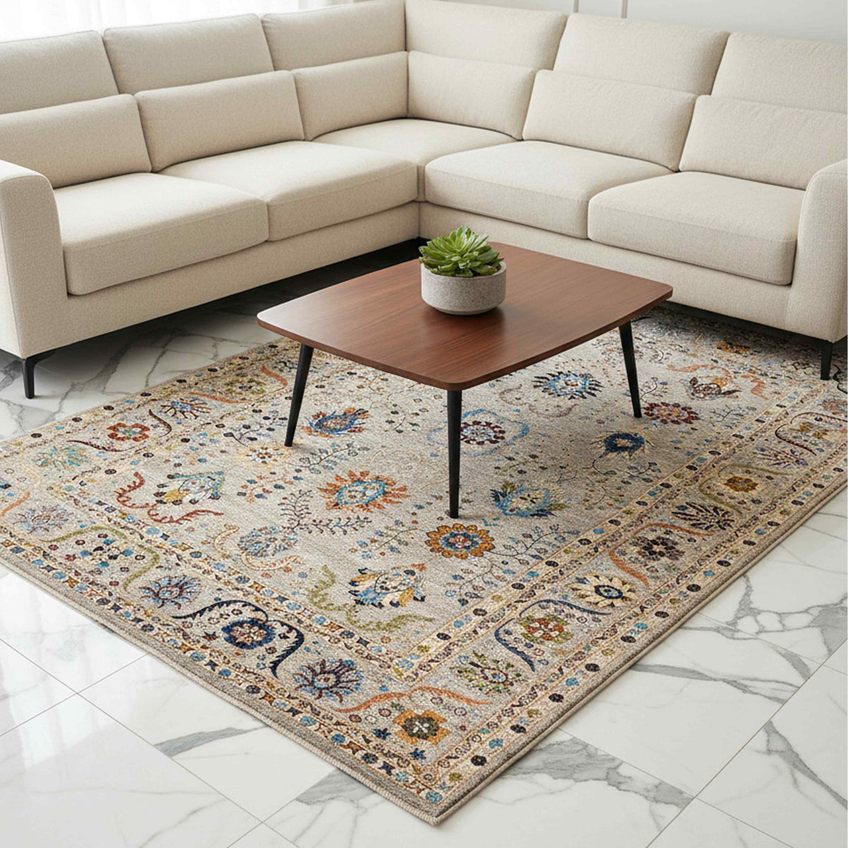 Light beige area rug with ornate blue and red floral pattern and short fringed border
