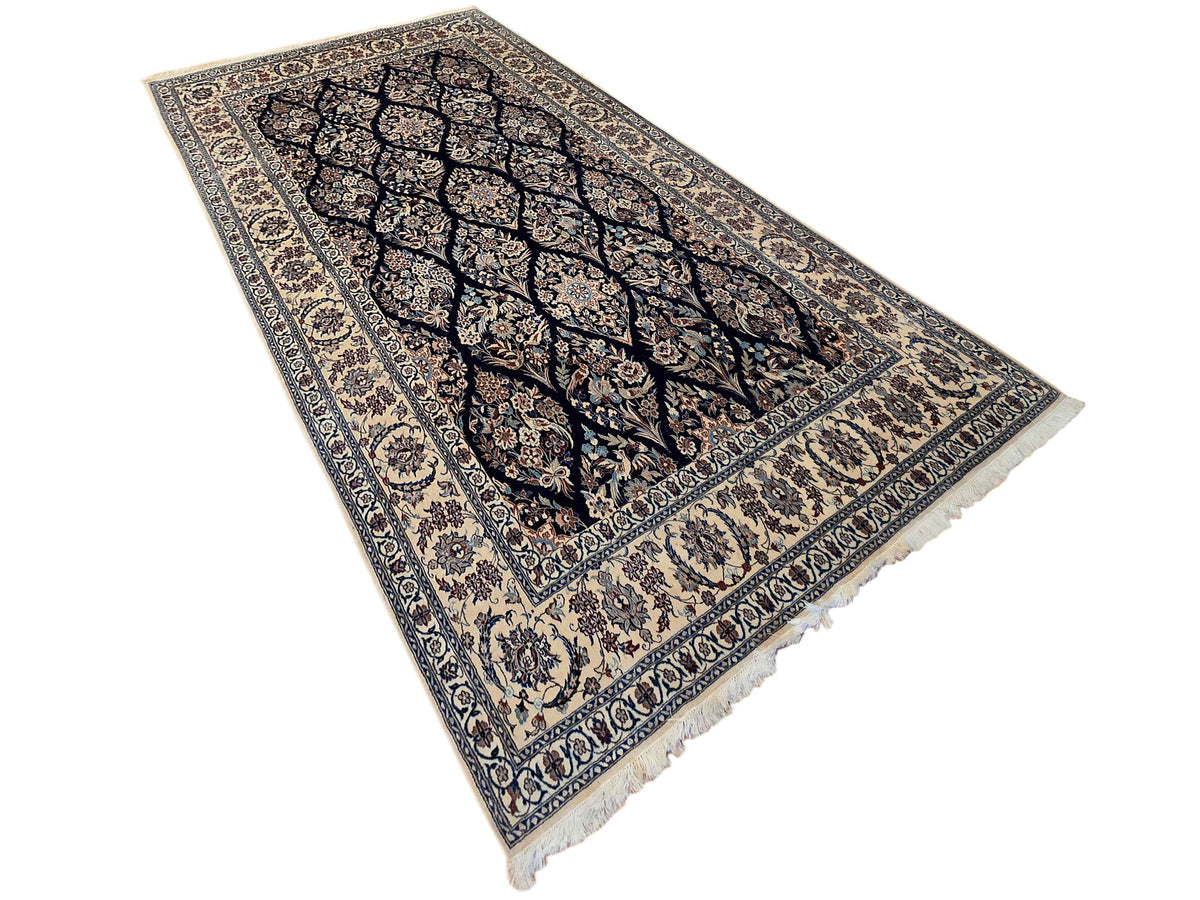 Navy and cream floral rug with decorative medallion, patterned border, and fringe