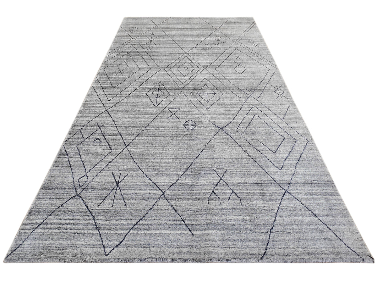 Gray rug with wide triangle layout and thin dark geometric diamond line motifs.