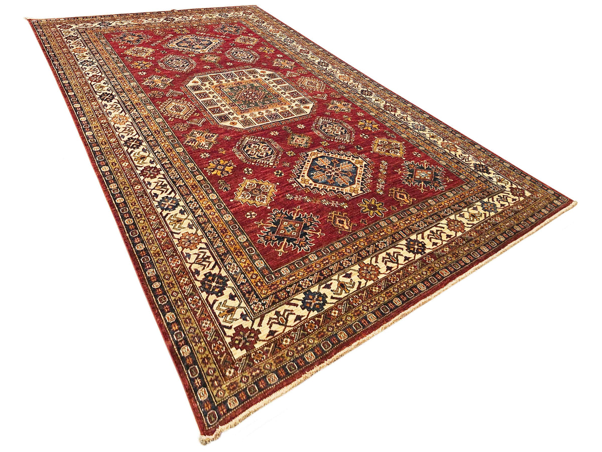 Rectangular red patterned rug with central medallion and cream ornamental border