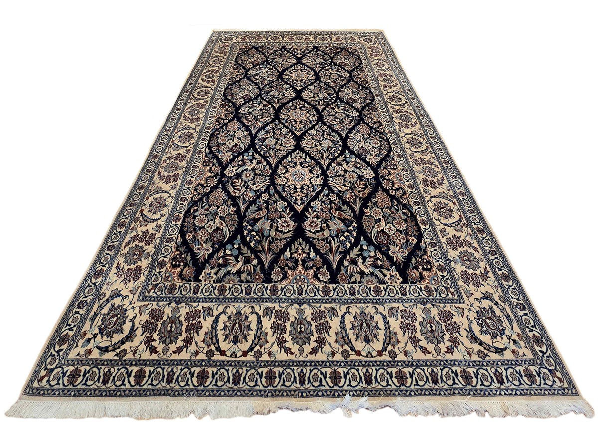 Navy and cream patterned area rug with central medallion, ornate border, and fringe
