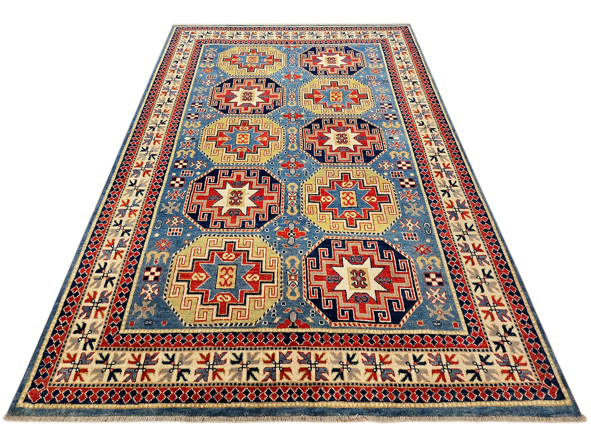 Kazak rug with central medallions on blue ground, red accents, and narrow geometric border.