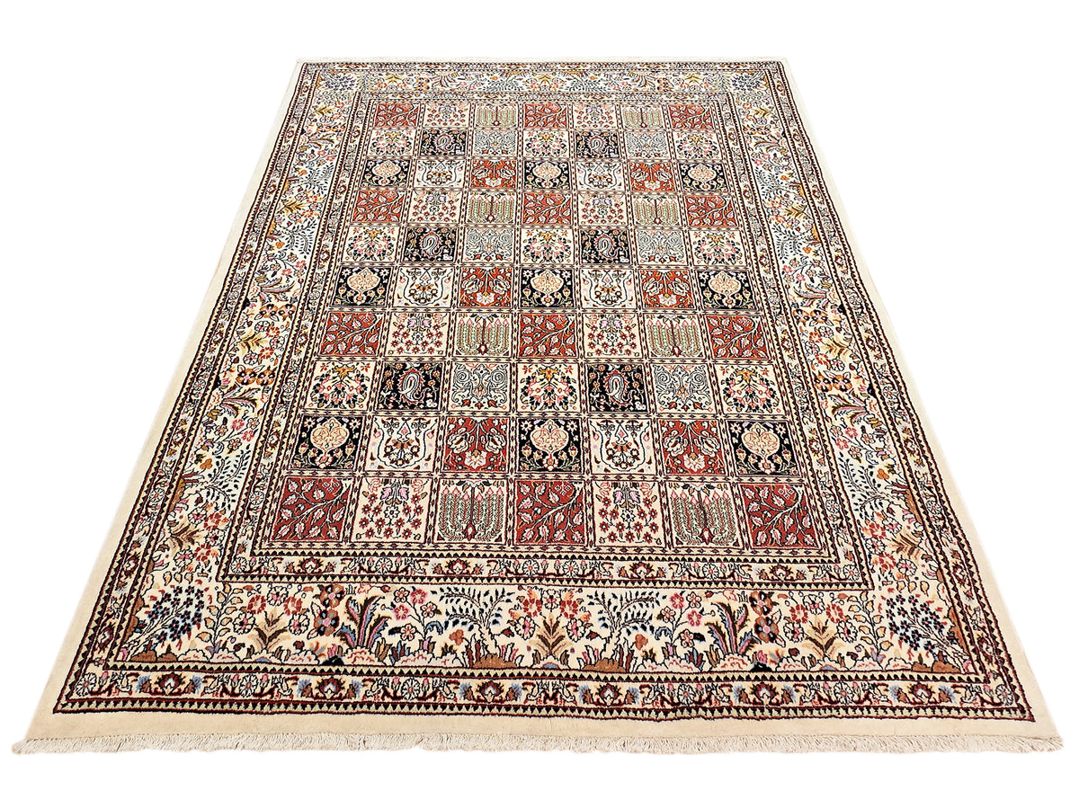 Top view of multicolor ornate area rug with central grid pattern and decorative border.