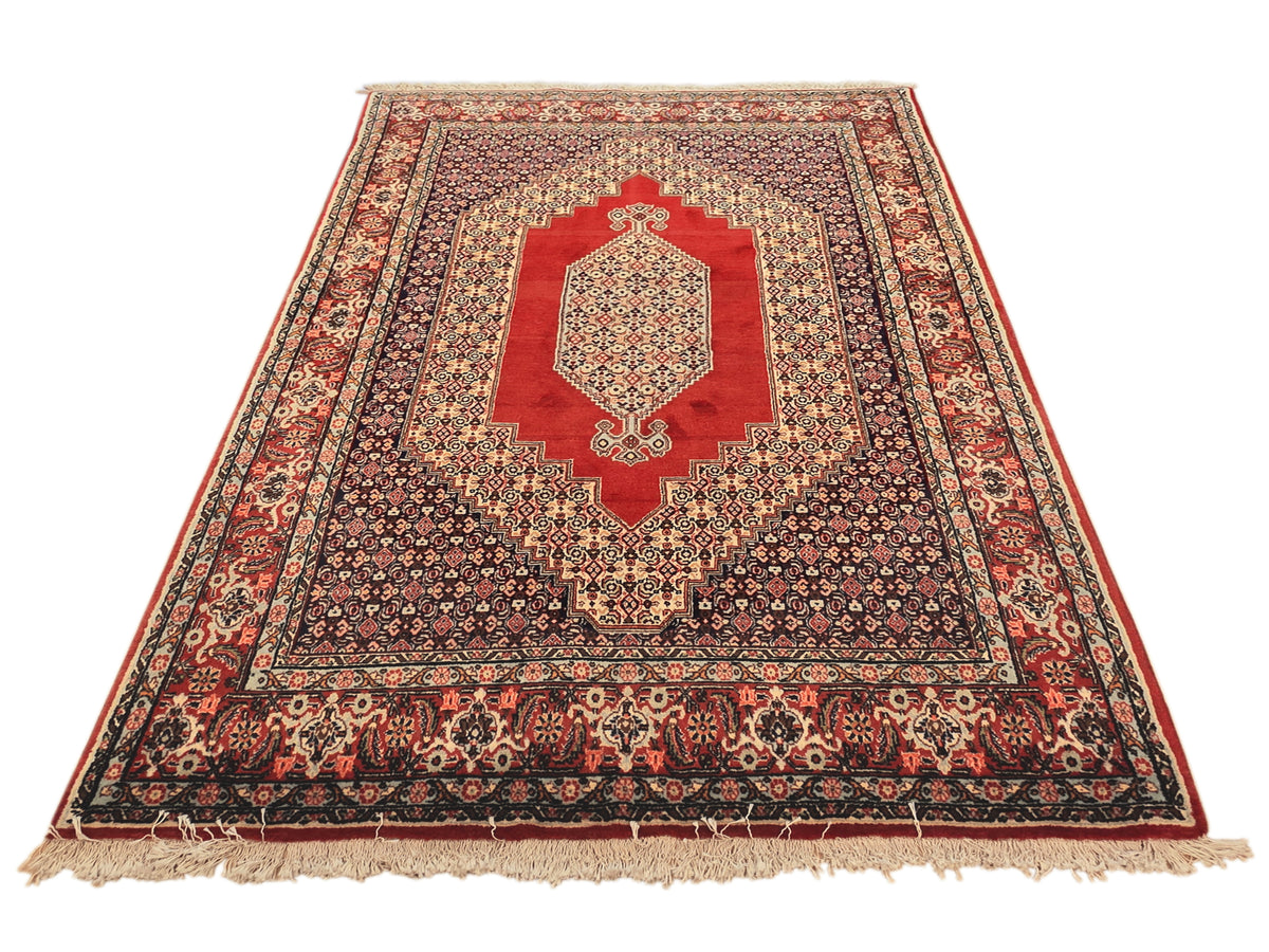 250x142 cm rug with red medallion and navy field, detailed borders, cream fringe
