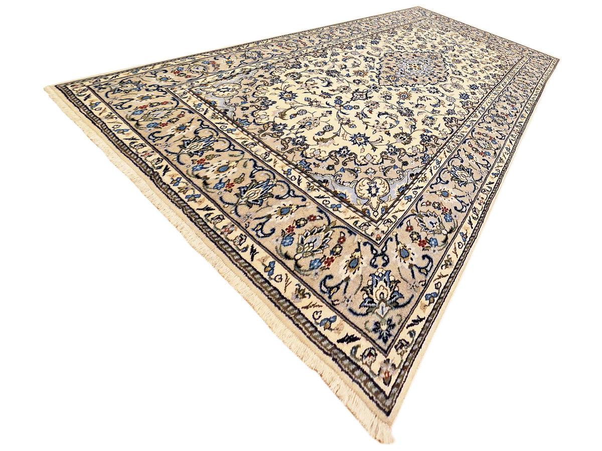 Kashan-style area rug with blue and cream floral medallion border, corner details