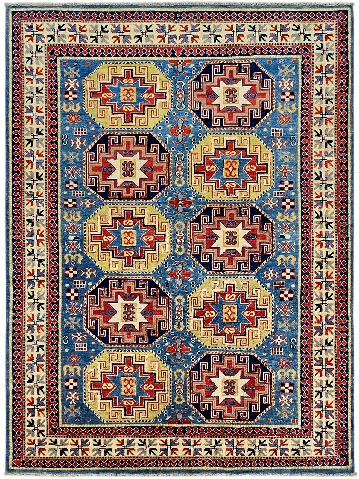 Kazak rug with blue field and five red-and-cream medallions, framed by ornate borders.