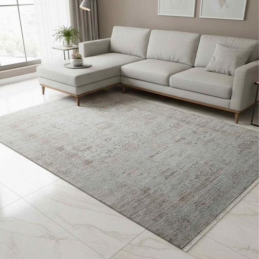 Light gray distressed area rug with large mottled abstract pattern