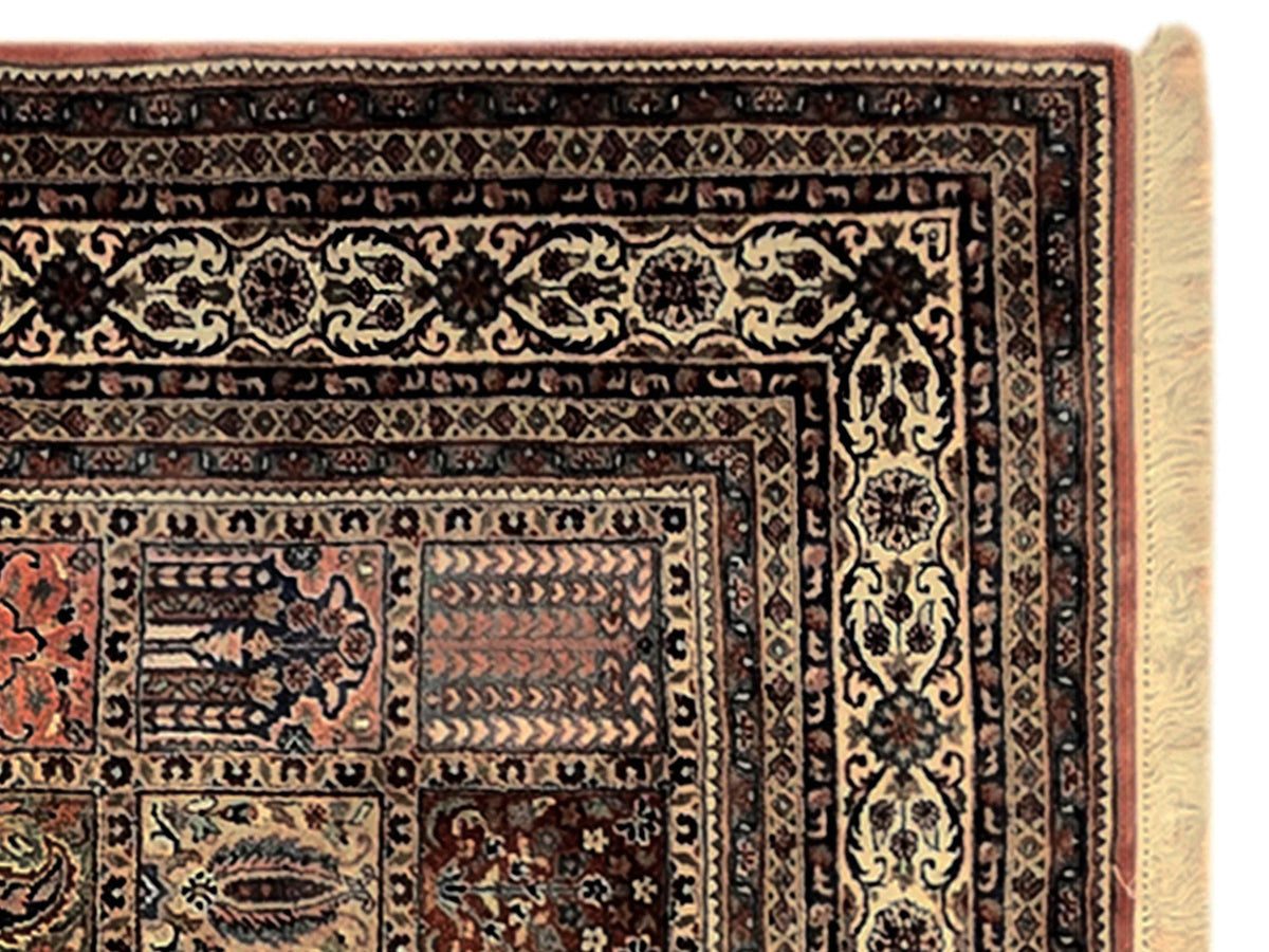 Close-up of multicolor Qum-style rug border with repeating motifs and dark outline