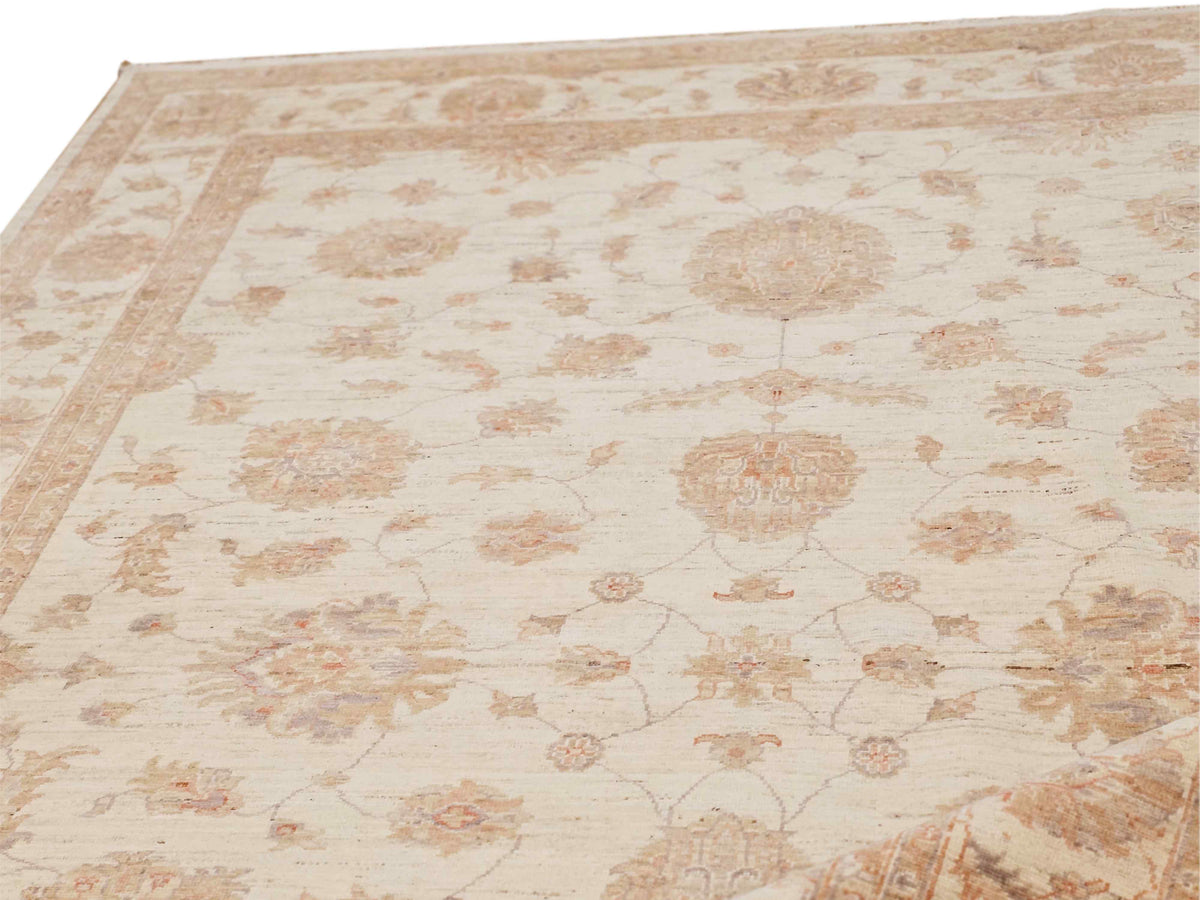 Close-up of cream rug field with connected floral vines and central medallion.