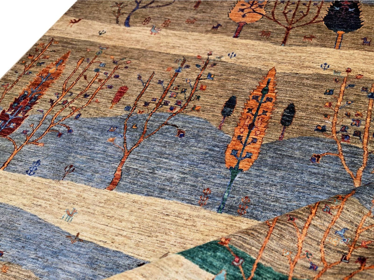 Ariana Gabbeh rug close-up showing blue panels and colorful tree branches