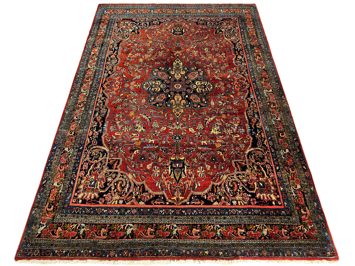 Oriental-style area rug with red field, dark blue border, and ornate motifs