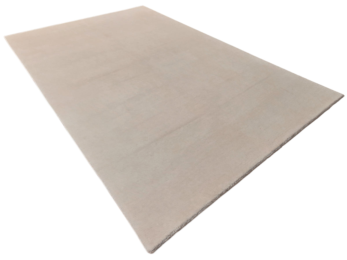 Light beige flatweave rug with a soft, solid color and neat, straight edges.