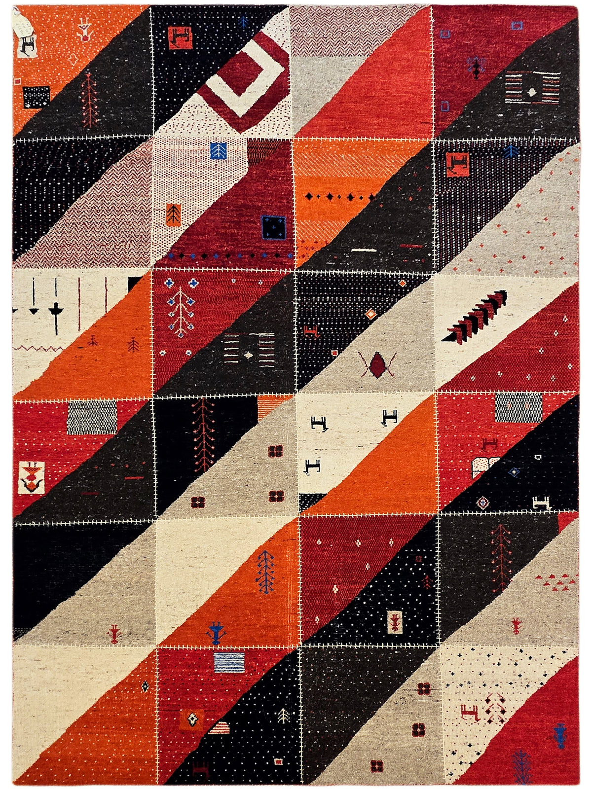 Full view rug pattern featuring red, orange, black, and cream patchwork rectangles