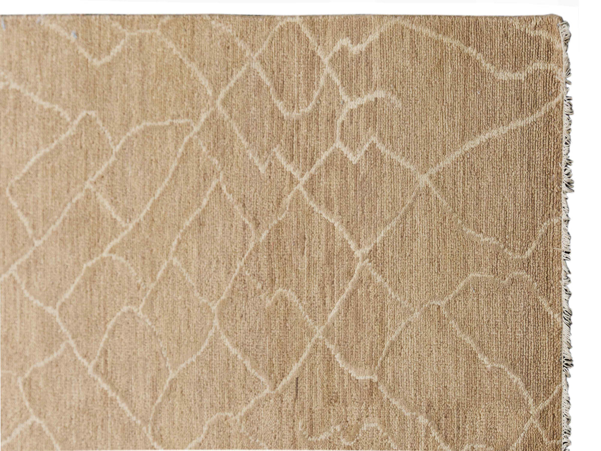 Beige textured crackle design rug with fringed edges on the side