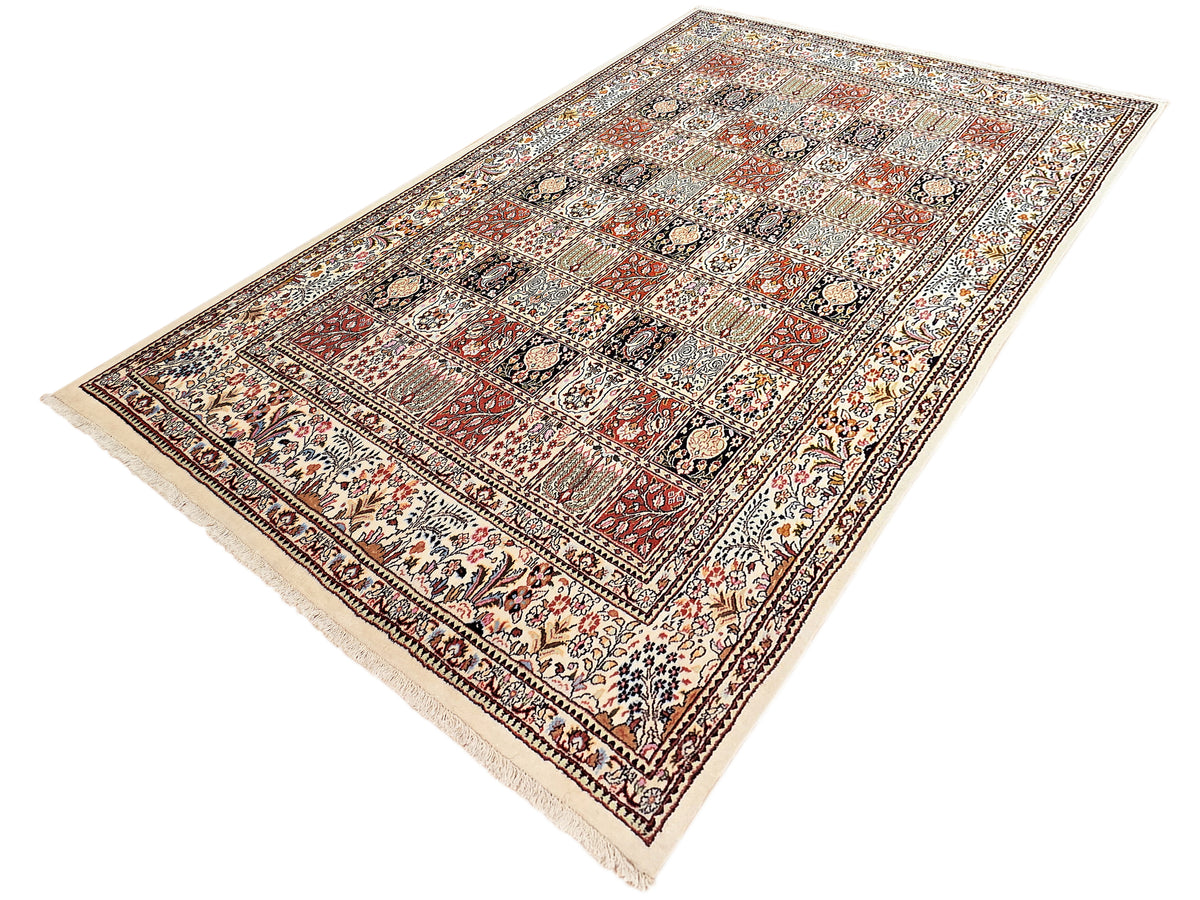Rectangular multicolor patterned area rug with fringed edges and decorative border.