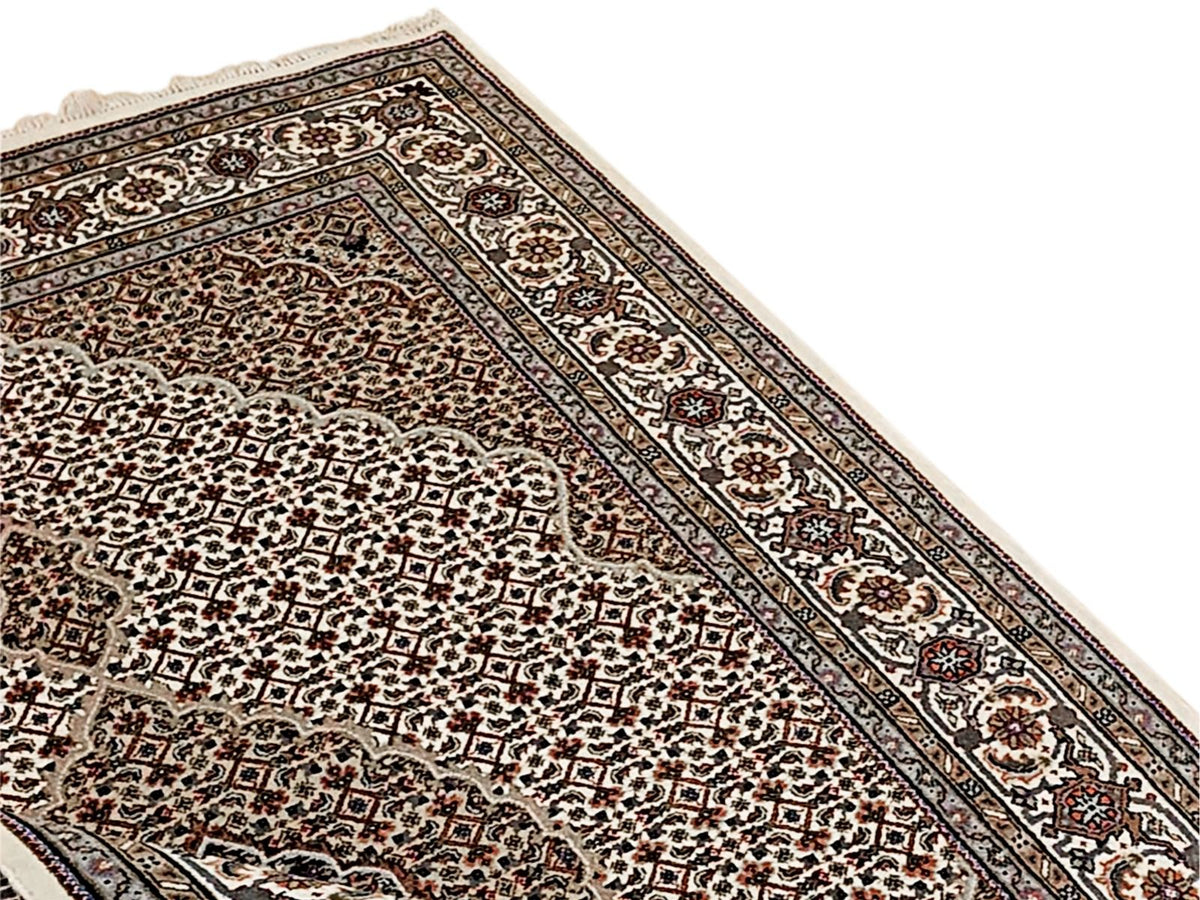 Oriental area rug with dark brown field, cream floral medallion and ornate border