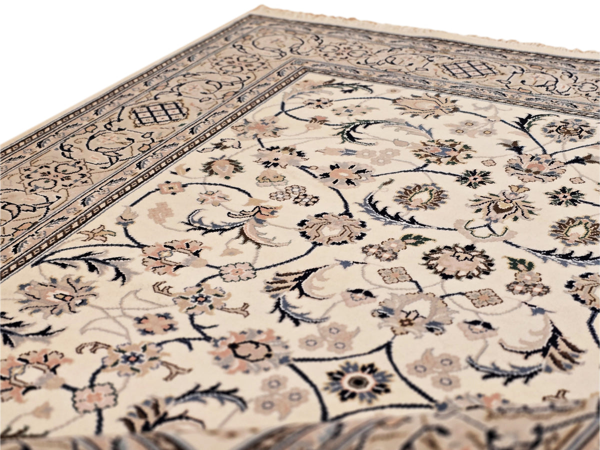 Nain rug close-up showing cream field, blue border stripe, and floral clusters