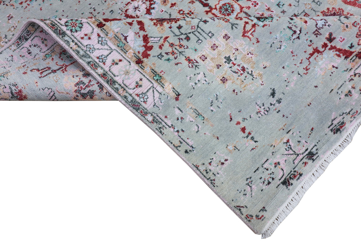 Oushak rug corner in light blue-gray with red splatter florals and navy geometric border