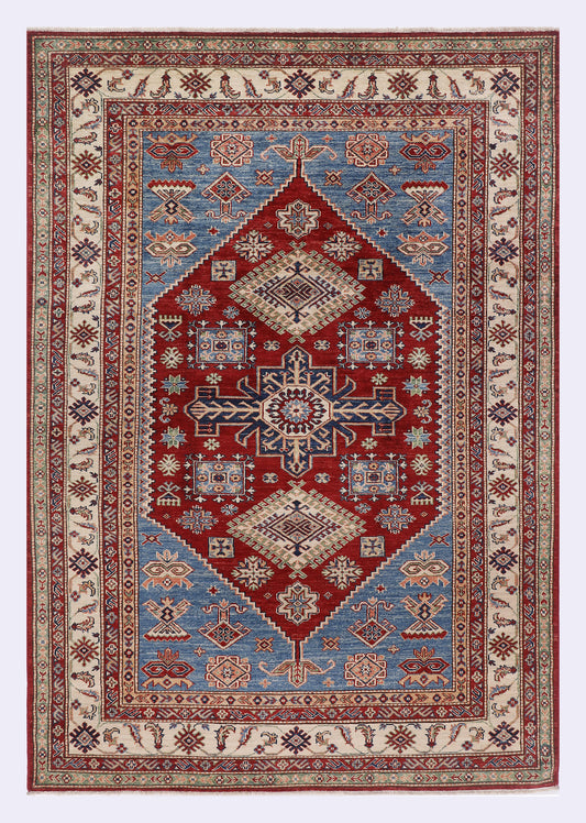 Red and navy patterned rug with geometric medallion center, border and ornate motifs
