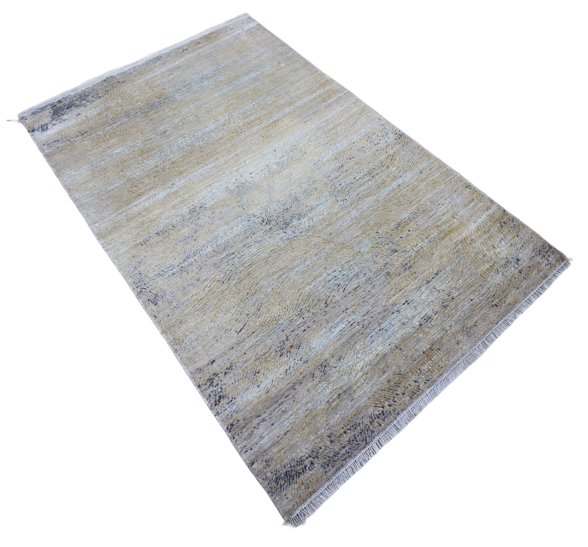 Diagonal view of rectangular modern rug with light blue, cream, and gray mottled pattern.