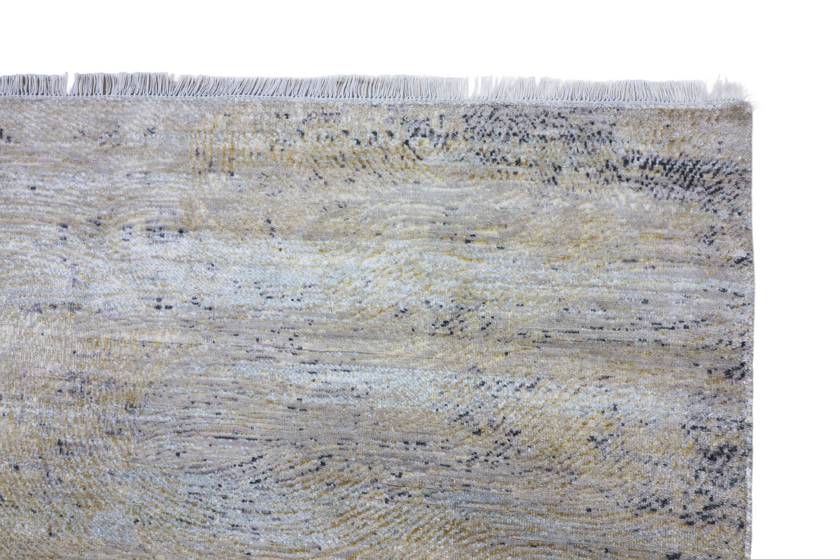 Close-up of light blue and cream textured area rug with fringe along the top edge.