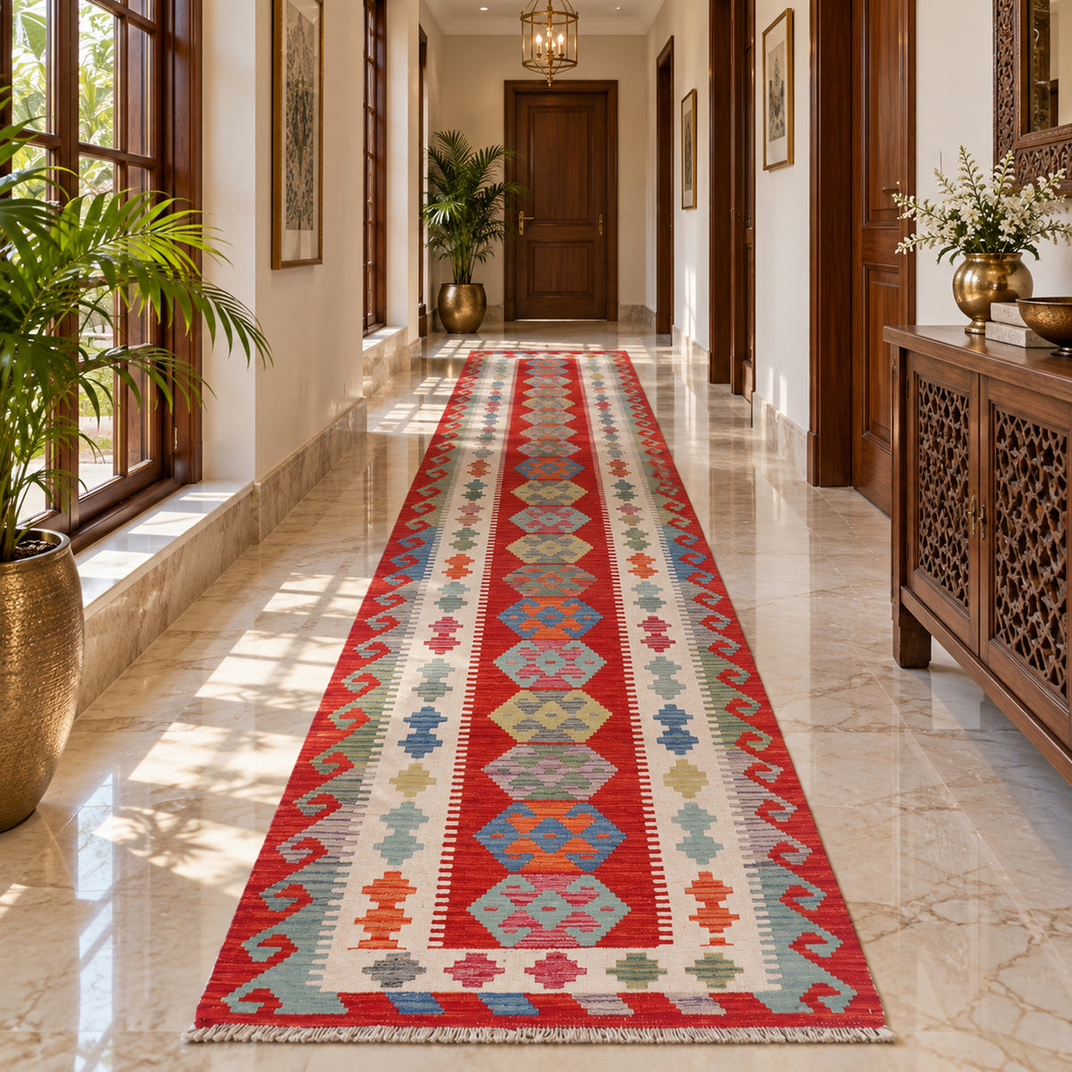 Kilim runner rug in red, cream, blue, and green geometric pattern laid along a hallway