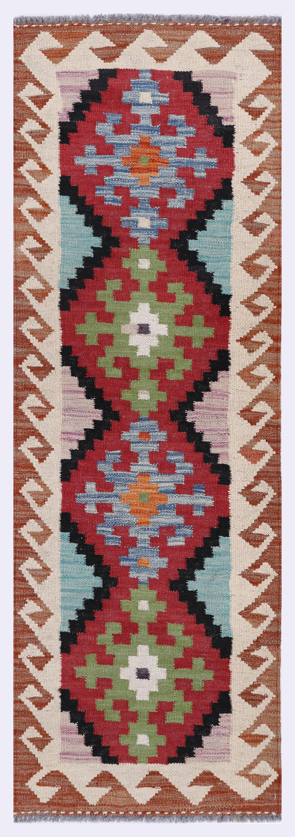 Red and blue geometric kilim rug with central medallion and zigzag border, long narrow.