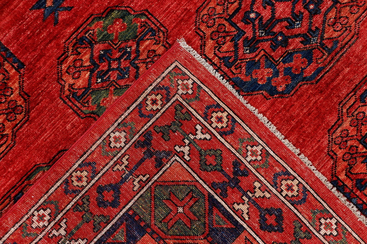 Red rug with central diamond medallion and ornate geometric pattern