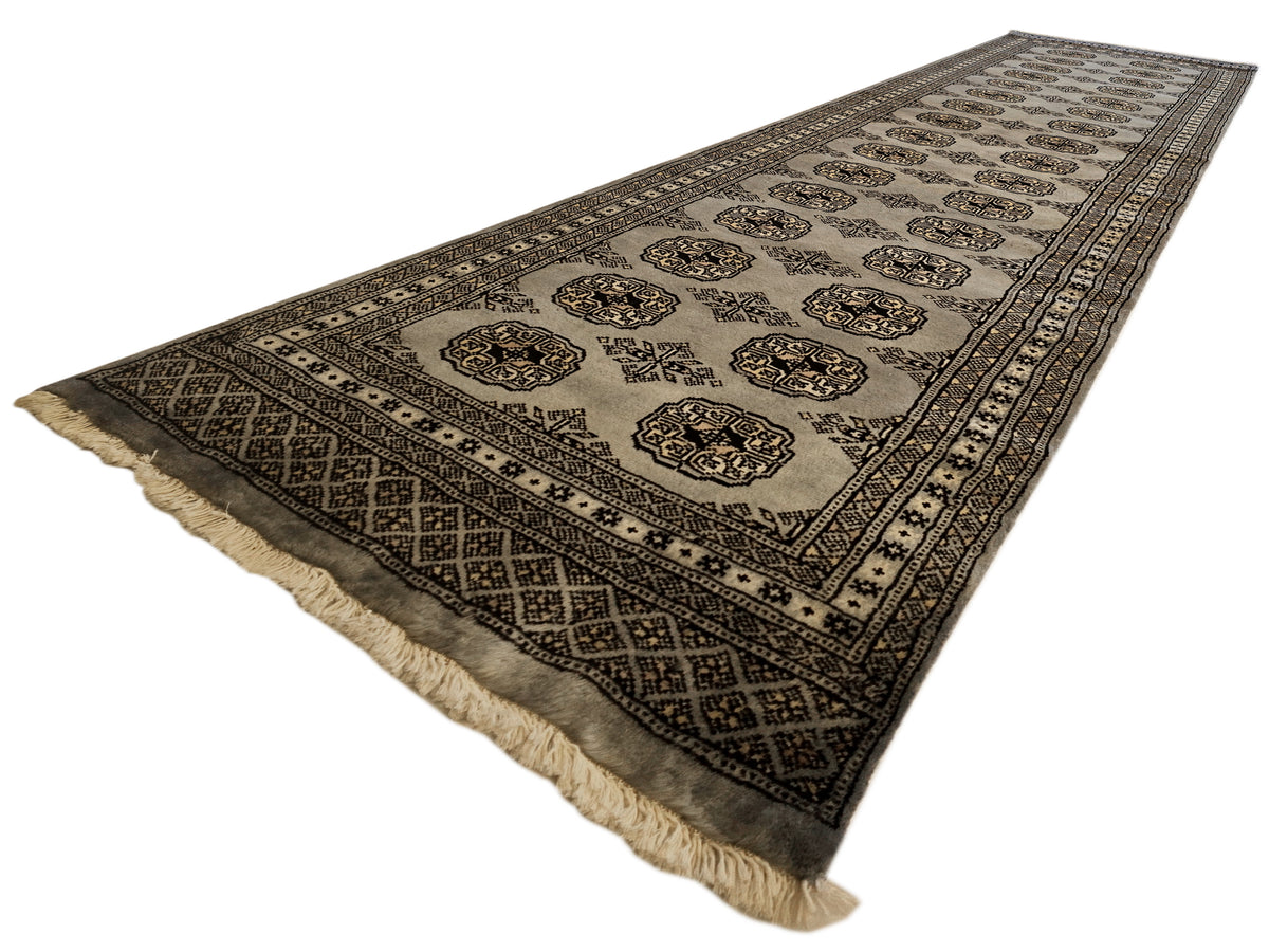 Rectangular rug with geometric border pattern and central medallion design, fringed ends